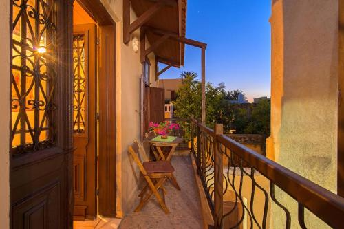 a balcony with a table and a chair on a porch at Muses-Old Town in Rhodes Town