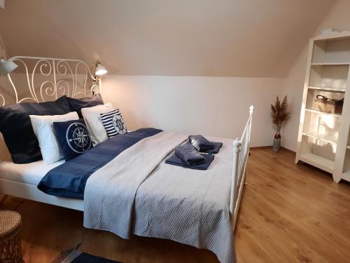 a bedroom with a bed with blue and white pillows at Villa Prima Wellness Badacsony in Badacsonytomaj