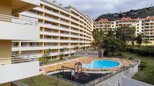 an external view of a hotel with a swimming pool at Green Park Ajuda Apartment in Funchal
