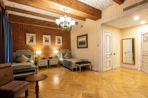 a living room with two beds and a couch at Sapphire Bayil Hotel in Baku