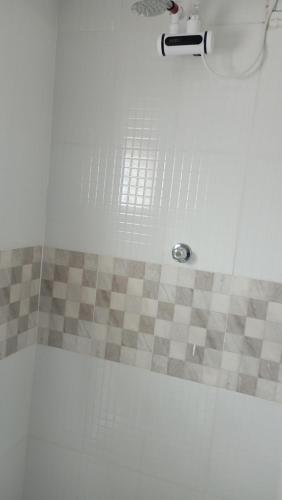 a bathroom with a shower with a tiled floor at Dunduzu village lodge in Mzuzu