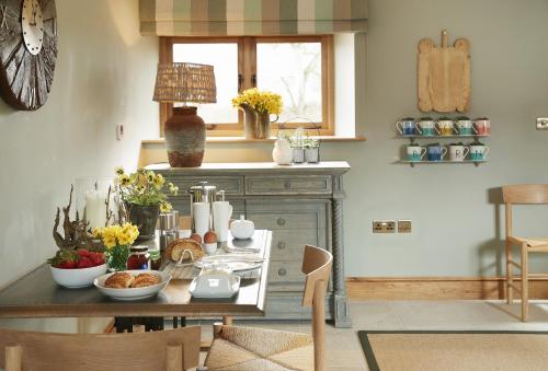 a kitchen with a table with food on it at The Stone Barn in Downton