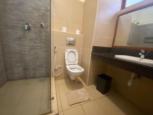 a bathroom with a toilet and a shower and a sink at Julia Ocean View Villa in Ukunda