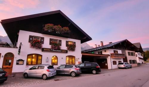 a group of cars parked in front of a building at Zum Franziskaner in Grainau