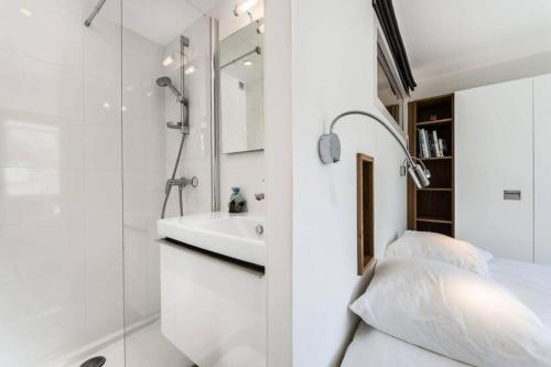 a white bathroom with a sink and a shower at Residence Saint-charles - 3 Pièces pour 5 Personnes 844 in Val-d'Isère