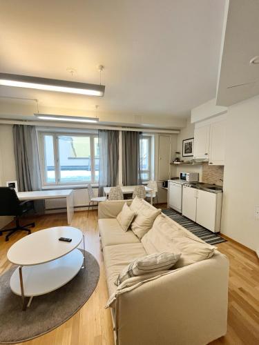 sala de estar con sofá y mesa en Kotimaailma Apartments Kamppi - 1BR for 3 persons, en Helsinki