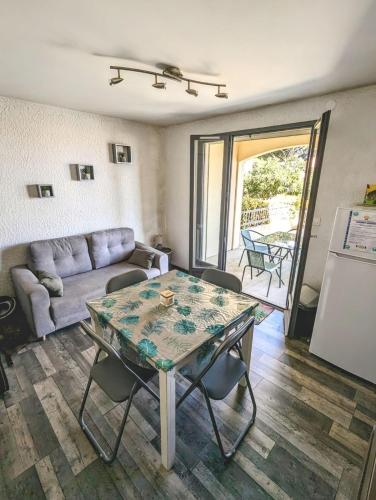 un salon avec une table et un canapé dans l'établissement La Pinède, à Gruissan