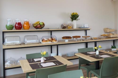 a dining room with tables and shelves with food at Luci di Assisi B&B Wellness in Assisi