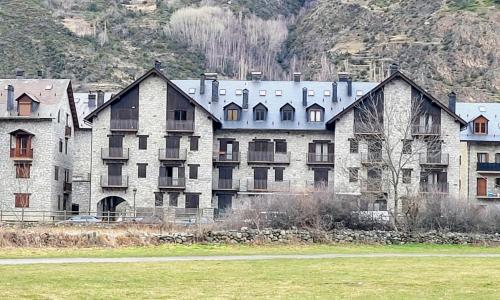 a large building with many windows in a field at Apartamentos Nogueret in Benasque