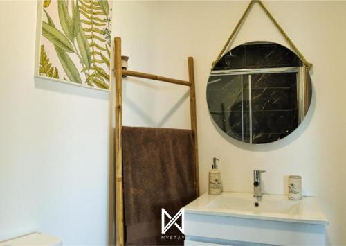 a bathroom with a sink and a mirror at MyStay - Casa das Oliveirinhas by Refúgio ao Luar in Celorico de Basto