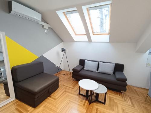 a living room with a couch and a table at SND Aparts in Novi Sad