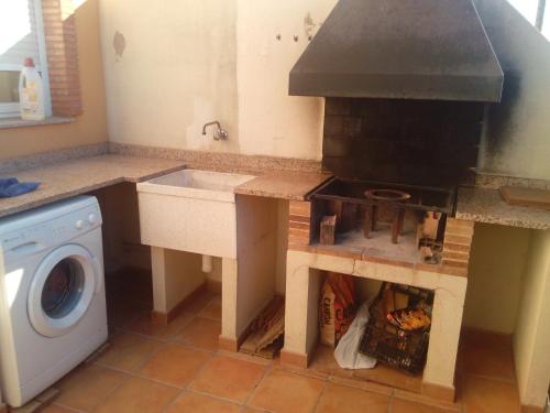 a kitchen with a stove and a sink in it at Miramar in Almazora