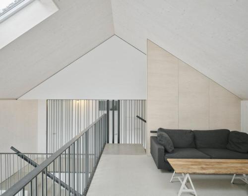 a living room with a couch and a table at TIROLER TRIS modern villa 10 beds in Maurach