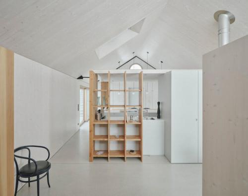a kitchen with a table and a chair in a room at TIROLER TRIS modern villa 10 beds in Maurach