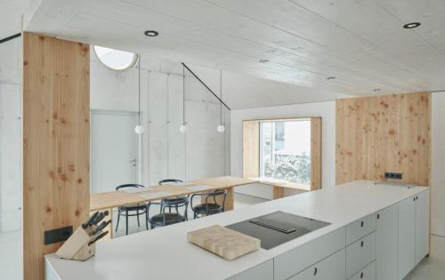 a large white room with a table and chairs at TIROLER TRIS modern villa 10 beds in Maurach