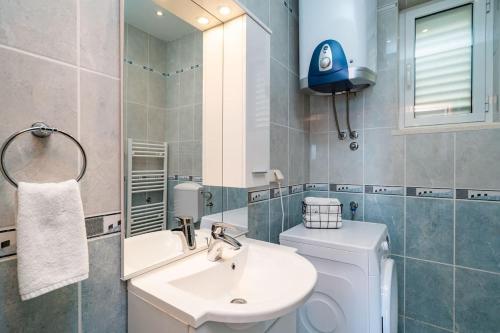 a bathroom with a sink and a toilet and a mirror at Chill Out - Old Town & Seaview Apartments in Dubrovnik