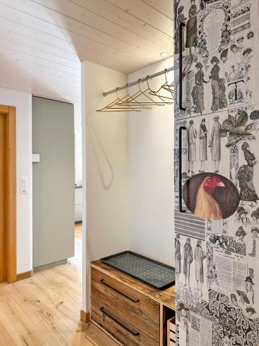 a room with a wall with drawings on it at Cosy Stopover near slopes and therms-Swiss Alps in Ovronnaz