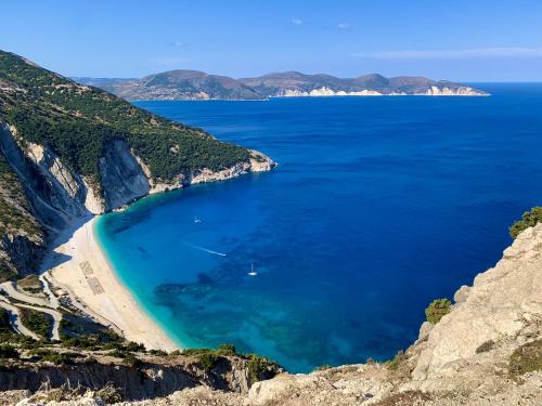 a beach on the side of a cliff at Villa Afroditi, Spartia, Kefalonia in Kefallonia