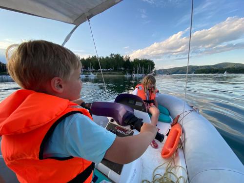 a boy and a girl on a boat on the water at Przystań Caryńska w Polańczyku in Polańczyk