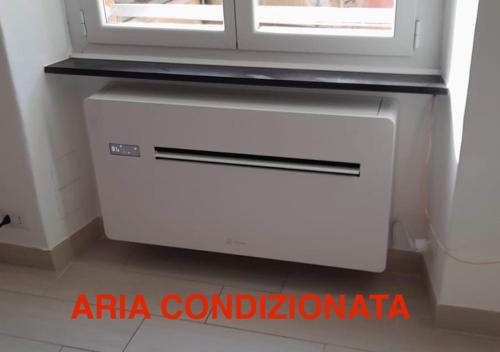 a white air conditioner in a room with a window at Civico 3 in Portofino