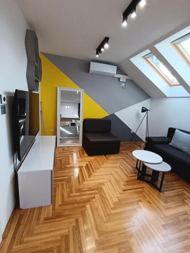 a living room with a couch and a table at SND Aparts in Novi Sad