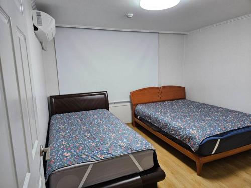 a small room with two beds in it at BA Stay in Suwon