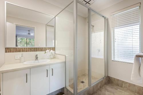 a white bathroom with a shower and a sink at Villa 16 @ Rivendell Winery Estate - Yallingup in Yallingup Siding