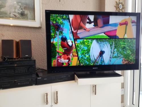 a flat screen tv sitting on top of a white cabinet at bello-horizonte Salou playa in Salou