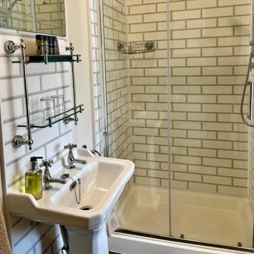 a bathroom with a sink and a shower at The Devonian in Ilfracombe