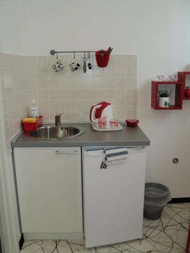 a small kitchen with a sink and a counter at Rooms Sobe ZG in Zagreb