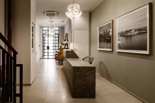 a hallway with a bench and a chandelier at The Sliema Suites in Sliema