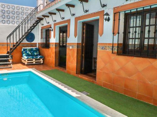 a house with a swimming pool next to a building at SEÑORÍO de MARÍN piscina climatizada exterior in Arriate