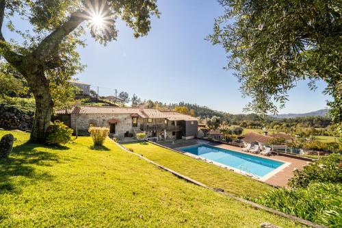 an estate with a swimming pool in a yard at Casa do Souto Vieira do Minho - Casa Rural com piscina by House and People in Vieira do Minho