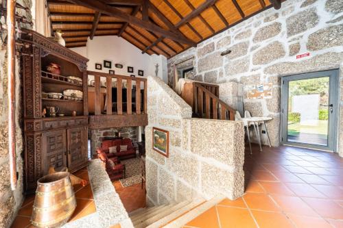 a stone house with a staircase and a stone wall at Casa do Souto Vieira do Minho - Casa Rural com piscina by House and People in Vieira do Minho