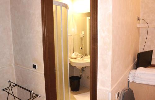 a bathroom with a sink and a mirror at Hotel Nettuno in Milan