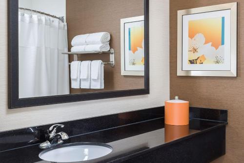 a bathroom with a sink and a mirror at Fairfield by Marriott in Jackson