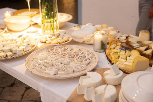 a table with cheese and other foods on it at Masseria Malvindi in Mesagne