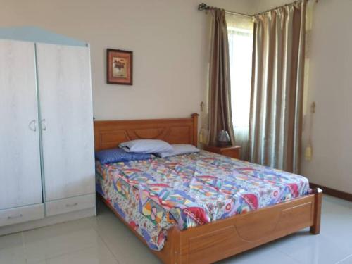 a bedroom with a bed and a large window at Heaven Heights - Fully Furnished Air Con Apartment in Rose Hill