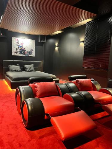 a living room with a couch and a bed at Cine47spa in Précy-sur-Oise