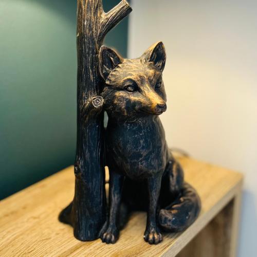 a statue of a fox sitting on a table at The Devonian in Ilfracombe
