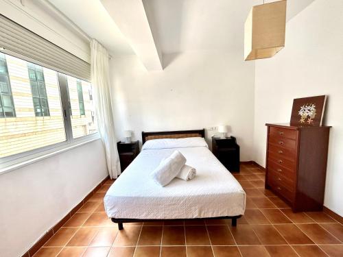 a bedroom with a bed and a dresser and a window at VibesCoruña - Bergondo 10 in A Coruña