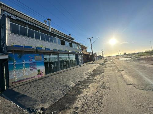 an empty street with a building on the side of a road at Flamingo Pé na Areia in Matinhos