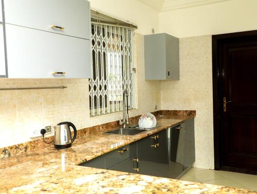 a kitchen with a sink and a counter top at Monarch Hotel in Accra