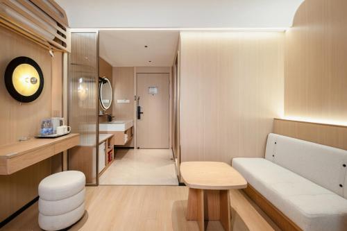 a small bathroom with a bench and a sink at Relax Hotel - Shenzhen Bao'an International Airport in Bao'an