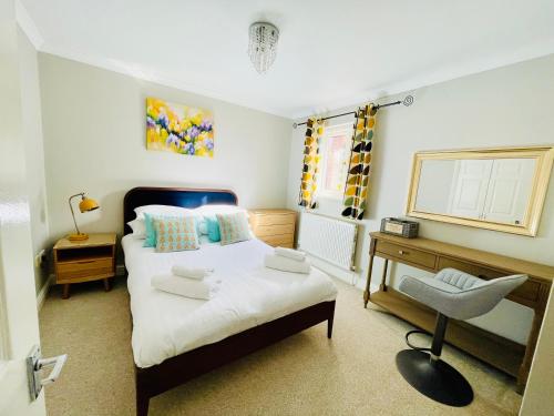 a bedroom with a bed and a desk and a chair at Tanglewood Close, 3 Bedroom house, Abergavenny with private parking, in Abergavenny