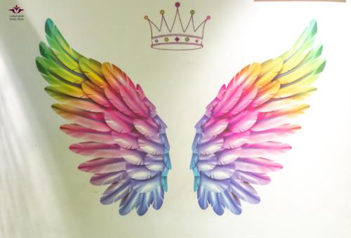 a pair of wings with a crown on it at Violet Al Azizia Hotel MASJID Al Qatari in Makkah