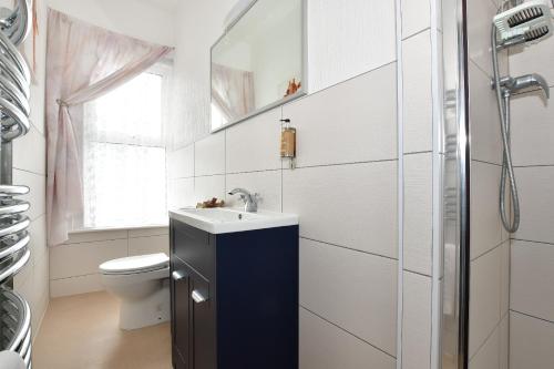 a bathroom with a sink and a toilet at Grange Bank House in Shanklin