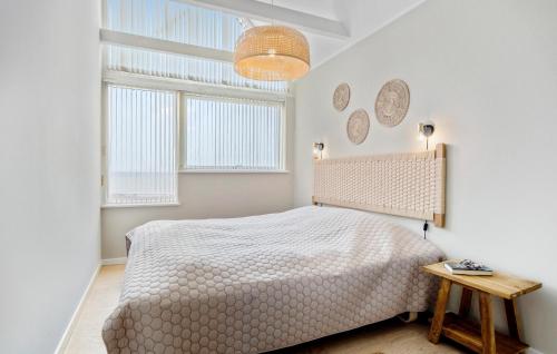 a white bedroom with a bed and two windows at Three-Bedroom Holiday Home In Assens in Assens