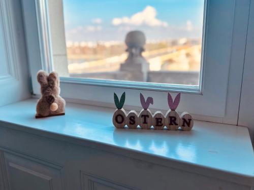 a stuffed animal sitting on a window sill at Danube Panorama apartments in Budapest