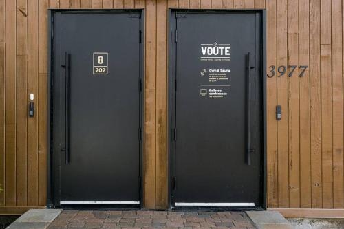 two black doors with the words vote on them at Complexe La Voûte by Gestion ELITE in Laval